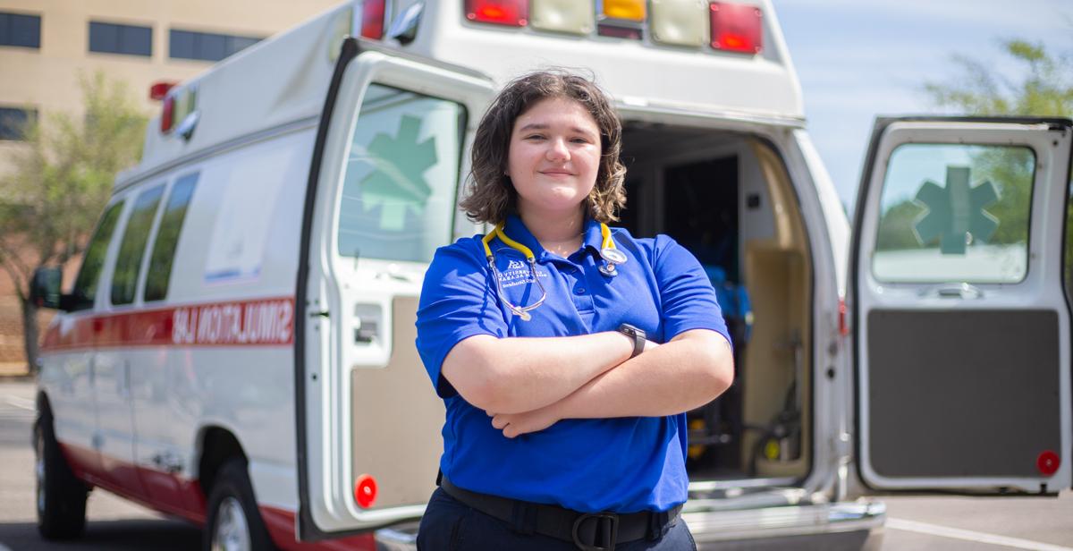 Chloé Knippers works part-time for a Mobile ambulance company. Here, she is in front of the University of South Alabama's Mobile Simulation Lab. 